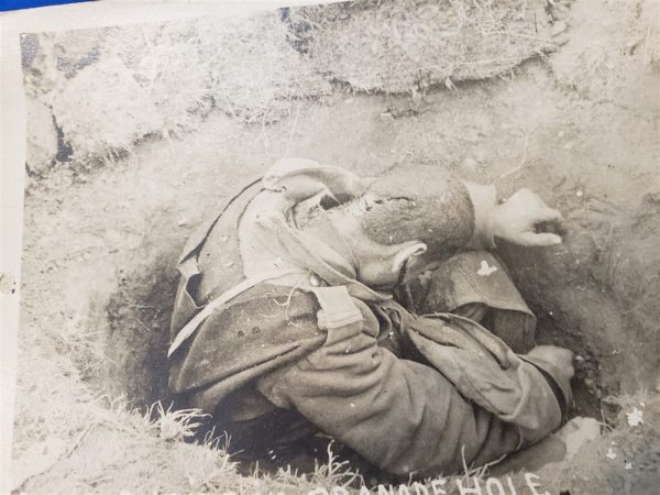 photo-of0dead-french-soldier-in-foxhole-with-head-wound-in-detail-clips-of-ammo-surrond-him-world-war-one