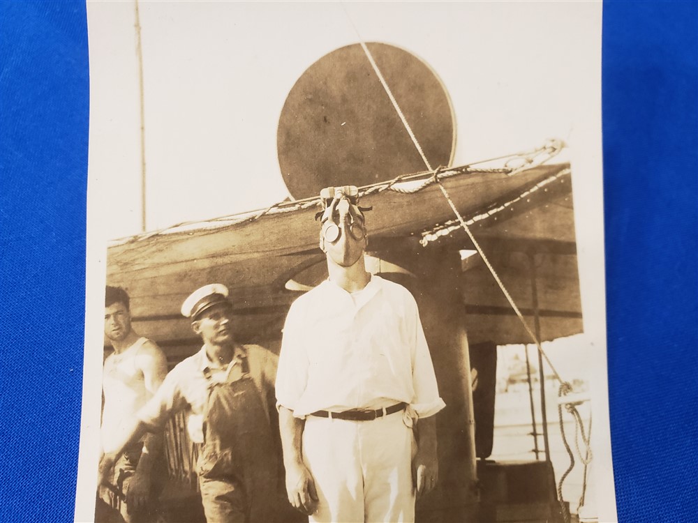 RPPC SAILOR MKII GAS MASK ABOARD SHIP. Very scarce photo of a Navy sailor wearing one of the early MKII variations of the gas mask. Excellent condition with writing of this man's name and wearing the mask on the back. Photoshoto-of-sailor-in-gas-mask-scarce-variation-aboard-ship-1918