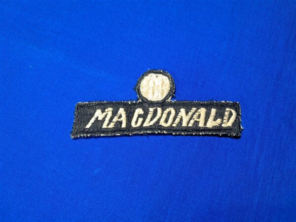 advisor-name-patch Vietnam-war-era-advisor-name-tape-with-unknown-symbol-or-rank-above-black-and-white-with-bird-in-circle