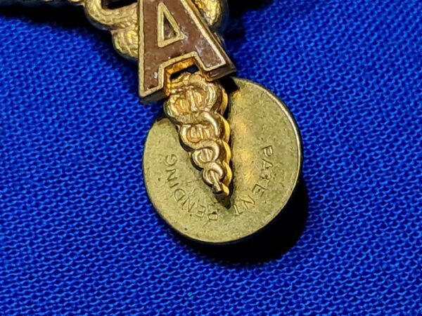 world-war-two-medical-officers-insignia-with-a-applied-in-brown-enemel-matched-set-unmarked